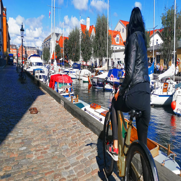 girl on bike in christianiahavn yachts harbour